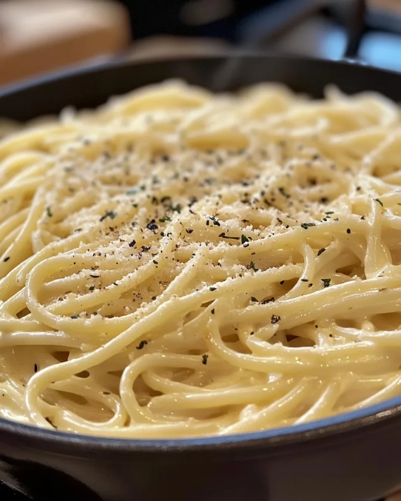 One pot creamy garlic pasta served in a bowl with herbs on top